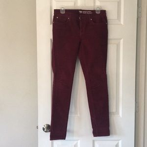Burgundy skinny corduroys.